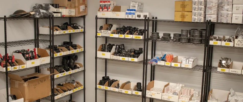 Shelves with irrigation components in a storage room.